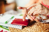 Senior woman calculating finances in her kitchen