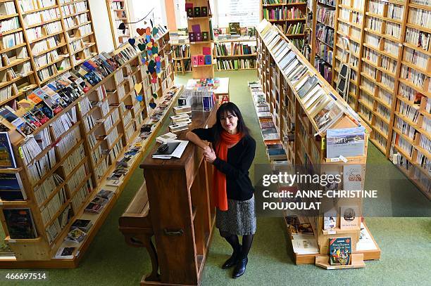 Christine Rey, new owner of the bookstore "Le Bleuet" poses on February 17, 2015 in her bookstore in Banon. AFP PHOTO / ANNE-CHRISTINE POUJOULAT