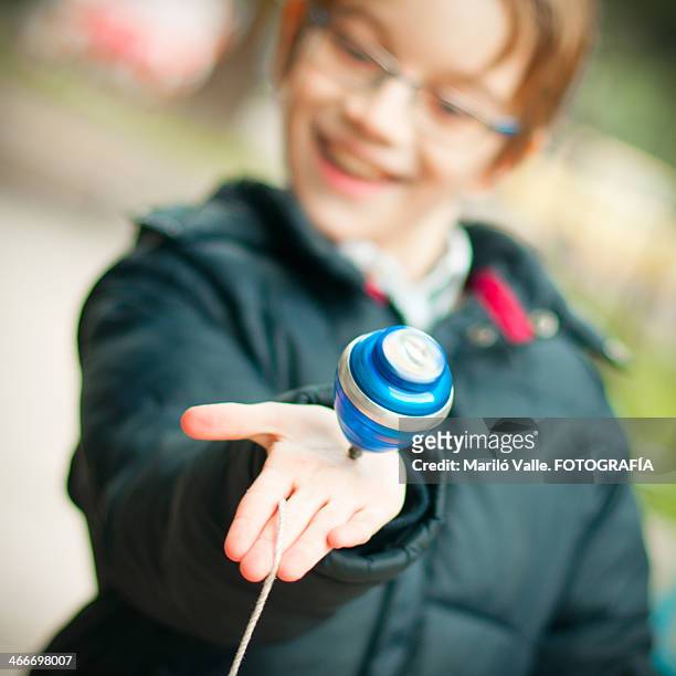 spinning top in child's hand - spinning top stock pictures, royalty-free photos & images