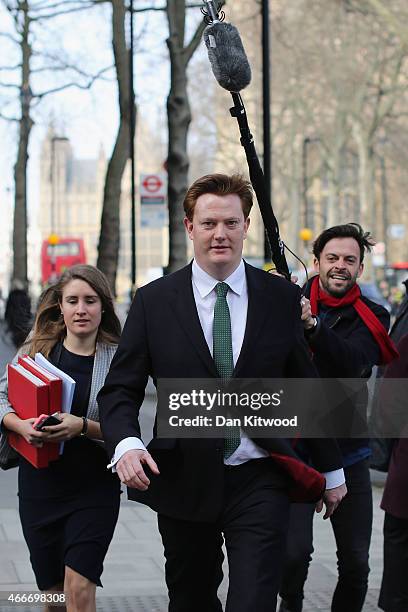 Britain's Chief Secretary to the Treasury Danny Alexander is followed by a TV crew as he walks through Westminster on March 18, 2015 in London,...