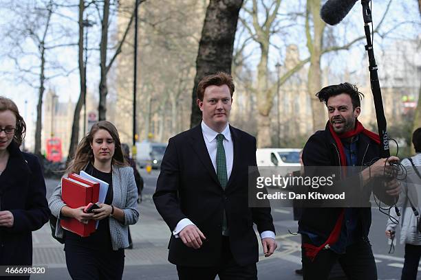 Britain's Chief Secretary to the Treasury Danny Alexander is followed by a TV crew as he walks through Westminster on March 18, 2015 in London,...