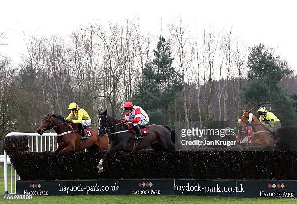 Winner Red Admirable ridden by Charlie Poste jumps the first Blenheim Brook in The ApolloBet Best Odds Guaranteed Handicap Steeple Chase during Irish...