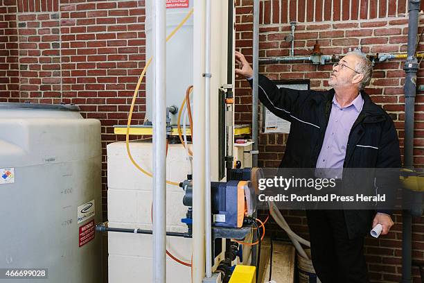 Kennebunk Water District Superintendent Norm Labbe inspects elements of the fluoride treatment room at the Kennebunk water plant in Kennebunk, ME on...
