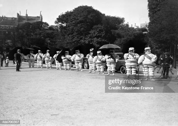 Bibendum Michelin men in front of the Paris Auto Show at the Grand Palais in October 1929 in Paris, France.