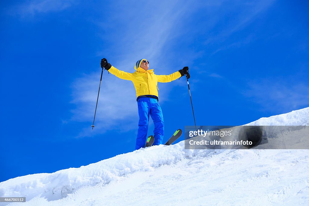 Happy men snow skier enjoying sunbathe on sunny ski resorts