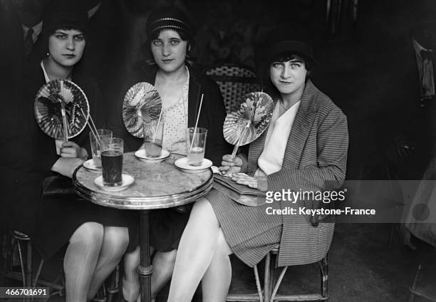 Young women having a drink in a cafe during the heat wave in July 1929 in Paris, France.