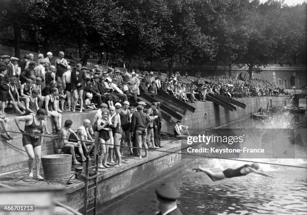 Swimmers diving in the Seine river during summer contest in July 1929 in Paris, France.