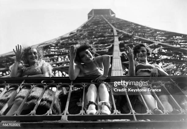 Dancers of famous Paris cabaret Moulin Rouge at the Eiffel Tower in September 1929 in Paris, France.