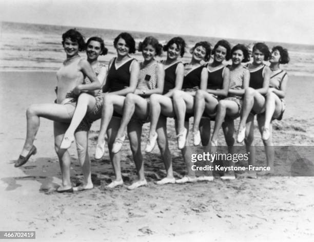 Circa 1920: English women dancing on the beach, circa 1920 in Ostend, Belgium.