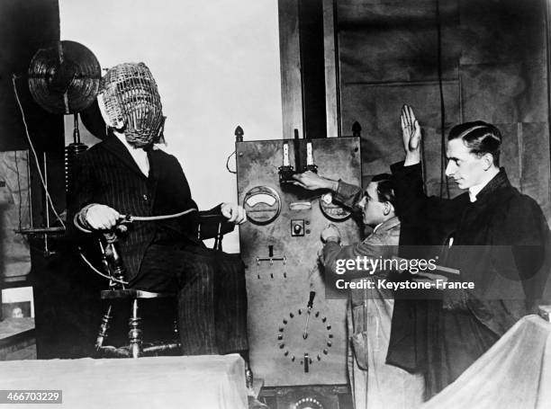 Priest giving the last blessing to a man sentenced to death on the electric chair in 1928 in the United States.