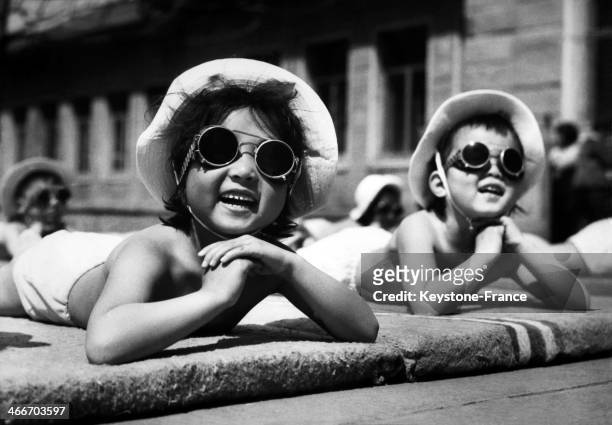 Children taking a sun bath in kindergarten in the Changchun province, on May 17, 1961 in China .