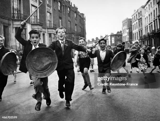 Young children of Paddington neighbourhood with dustbin lids for shields and bits of wood for lances defend their street from the invasion of our...