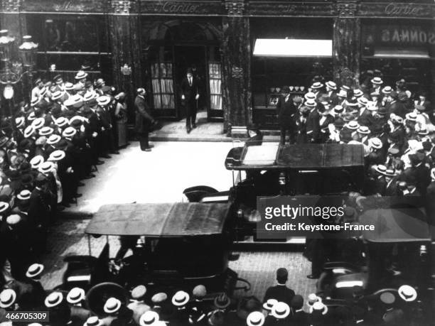 King of Spain Alfonso XIII walks out of the Cartier store in the Rue de la Paix, surrounded by a crowd of spectators in 1922 in Paris, France.