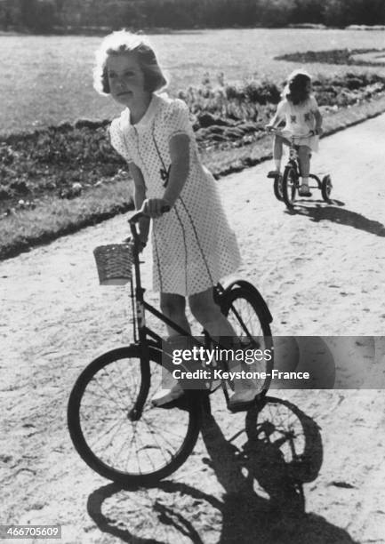 Princess Margaretha and her sister Princess Desiree, daughters of Crownprince Gustaf Adolf and of Princess Sibylla, cycle in the park of Haga Castle...