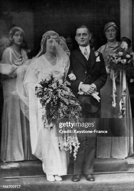 Princess Juliana, being on the right and holding flowers, is at the wedding of one of her bridesmaid in The Hague, Netherlands.