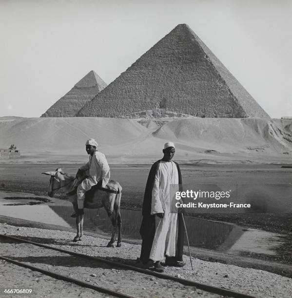 Circa 1910: Bedouins in front of the Great Pyramids of Giza, circa 1910 in Giza, Egypt.