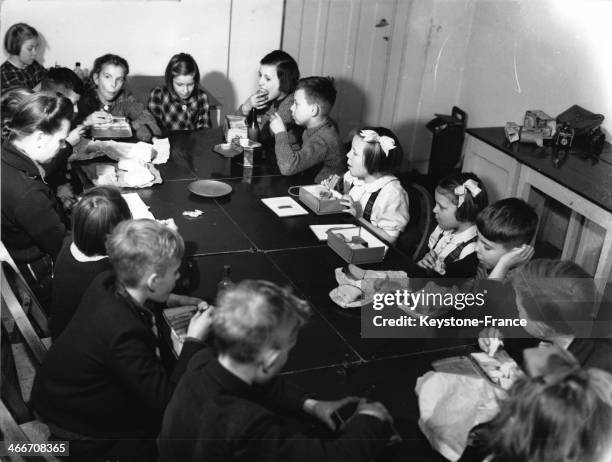 Crown Princess Beatrix and Princess Irene, surrounded by pupils, at the primary school De Werkplaats in March 1946 in Bilthoven, Netherlands.