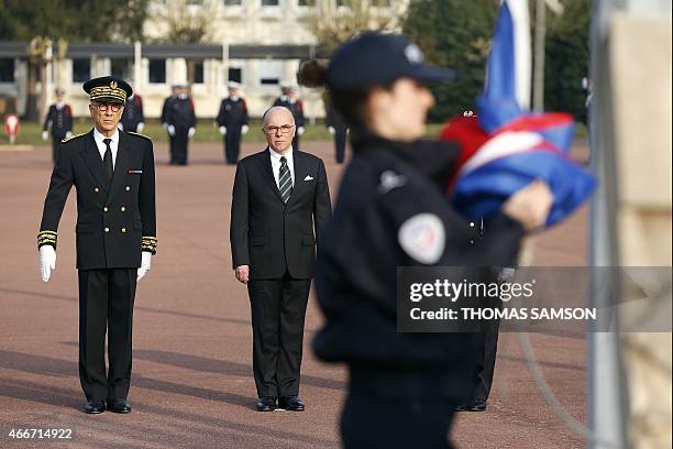 French Interior Minister Bernard Cazeneuve and Seine-et-Marne Prefect Jean-Luc Marx Helene Martini attend a graduation ceremony at the Ecole...