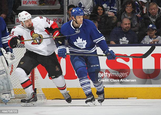Matt Kassian of the Ottawa Senators skates against Tim Gleason of the Toronto Maple Leafs during an NHL game at the Air Canada Centre on February 1,...