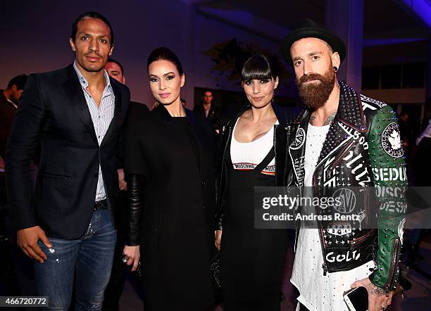 Footballer Bruno Alves, guest, footballer Raul Meireles and Ivone Meireles pose prior the Hakan Akkaya show during Mercedes Benz Fashion Week...