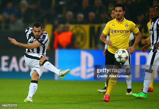 Carlos Tevez of Juventus scores the opening goal during the UEFA Champions League Round of 16 between Borussia Dortmund and Juventus at Signal Iduna...