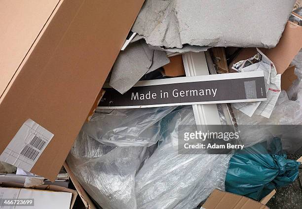 Sign reading 'Made In Germany' lies on a pile of trash on the sidewalk on February 3, 2014 in Berlin, Germany. Jacob Lew, the U.S. Treasury...