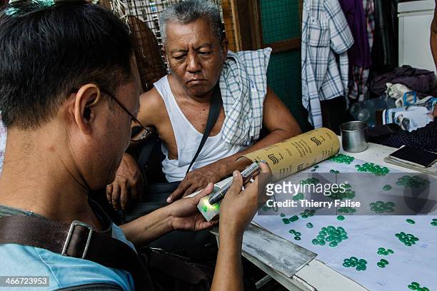Dealers sell polished stones in the Mandalay jade market. Jade is extracted from the Hpakant mines in Kachin State.