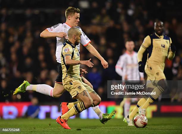 Matt Smith of Fulham is tackled by Giuseppe Bellusci of Leeds United during the Sky Bet Championship match between Fulham and Leeds United at Craven...