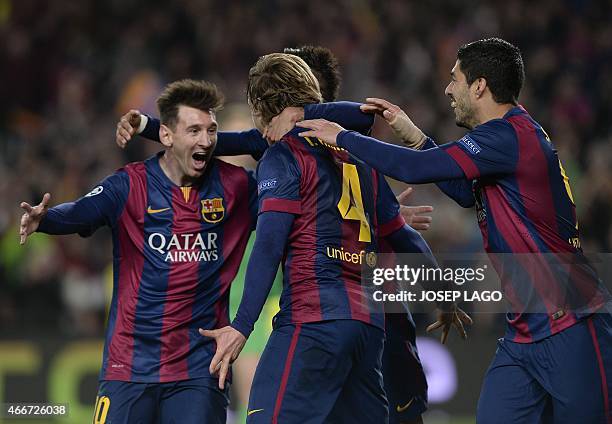 Barcelona's Croatian midfielder Ivan Rakitic is congratulated by his teammate Barcelona's Argentinian forward Lionel Messi after scoring during the...