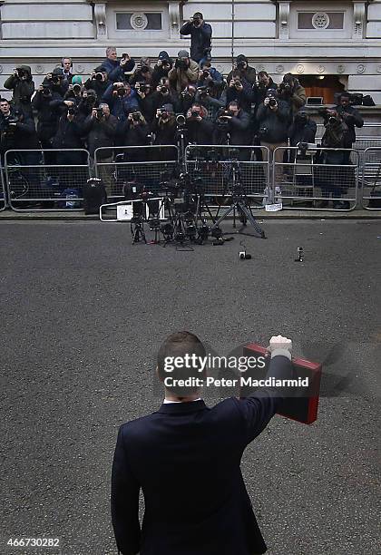 Chancellor of the Exchequer George Osborne holds his ministerial red box up to photographers as he stands outside number11 Downing Street on March...