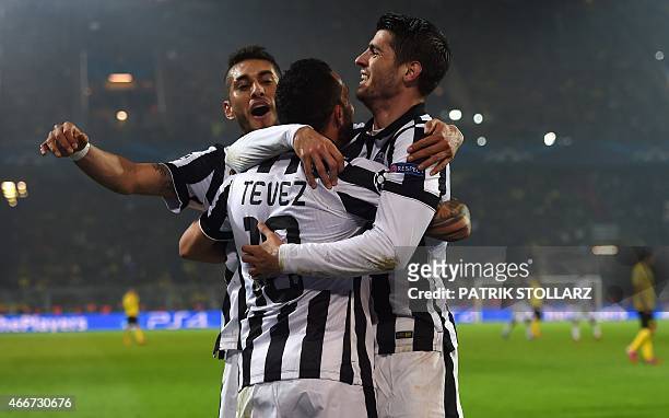 Juventus' Spanish forward Alvaro Morata and Juventus' Argentinian forward Carlos Tevez celebrate during the Round of 16, second-leg UEFA Champions...