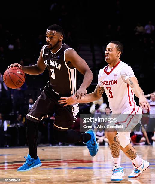 St. Bonaventure Bonnies dribbles past Kyle Davis of the Dayton Flyers during a quarterfinal game in the 2015 Men's Atlantic 10 Basketball Tournament...