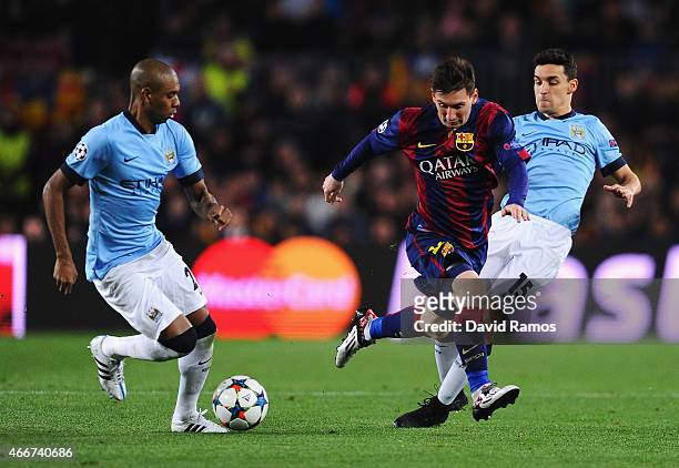 Lionel Messi of Barcelona is challenged by Jesus Navas of Manchester City during the UEFA Champions League Round of 16 second leg match between...