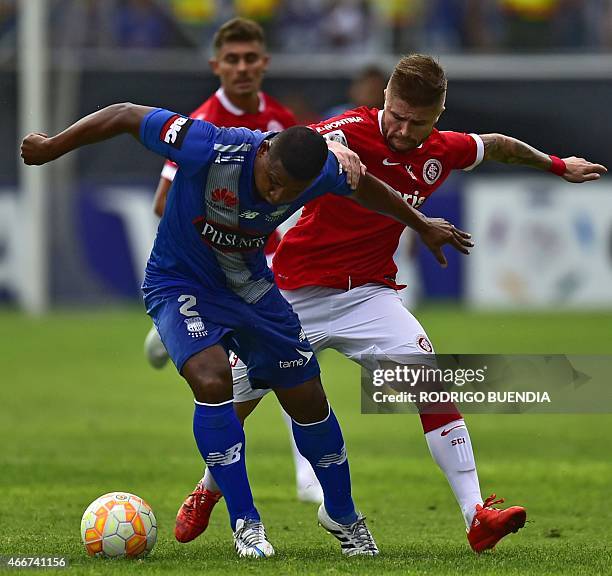 Brazil's Internacional football player Eduardo Sasha vies for the ball with Ecuador's Emelec Jorge Guagua during their Copa Libertadores football...