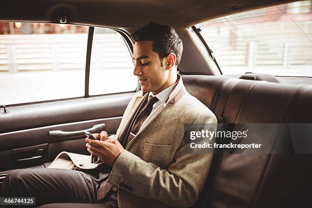 geschäftsmann auf ein yellow cab sms - businessman taxi stock-fotos und bilder