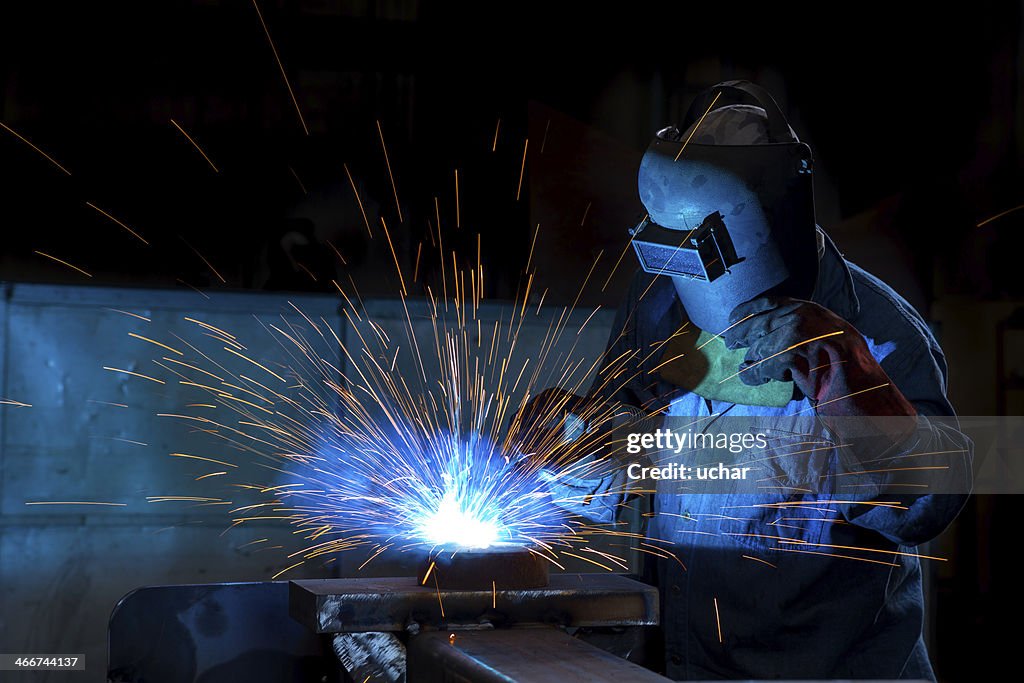 Close-up of a welder wielding sparks