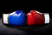 Red and Blue Boxing Gloves on a Black Background