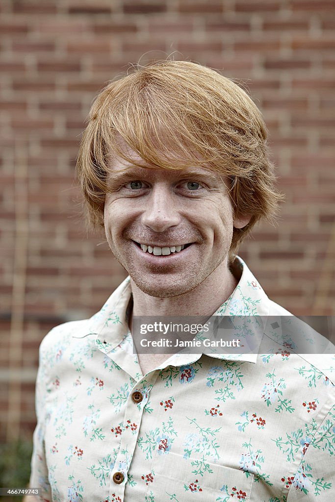 Portrait of ginger haired male smiling