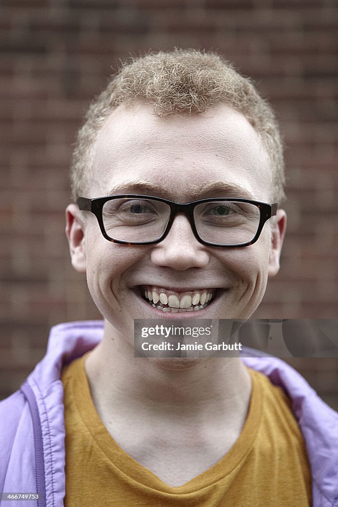 A portrait of a young male with blonde curly hair