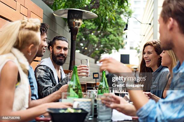 group of friend eating outdoors - carbonated water stock pictures, royalty-free photos & images