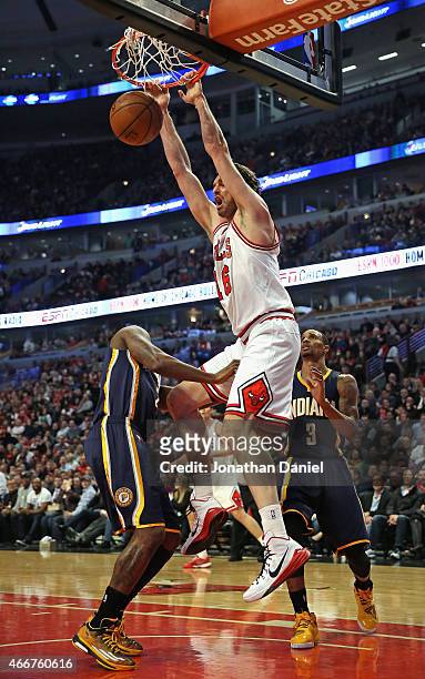 Pau Gasol of the Chicago Bulls dunks over Rodney Stuckey and George Hill of the Indiana Pacers at the United Center on March 18, 2015 in Chicago,...
