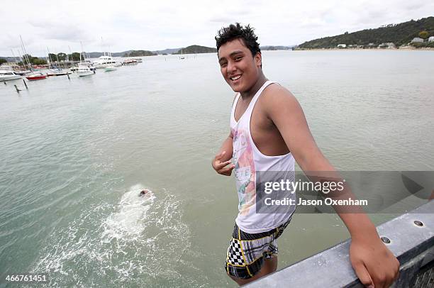 Local boy Thomas Grace prepares to jump from Waitangi River bridge on February 4, 2014 in Paihia, New Zealand. The Waitangi Day national holiday...