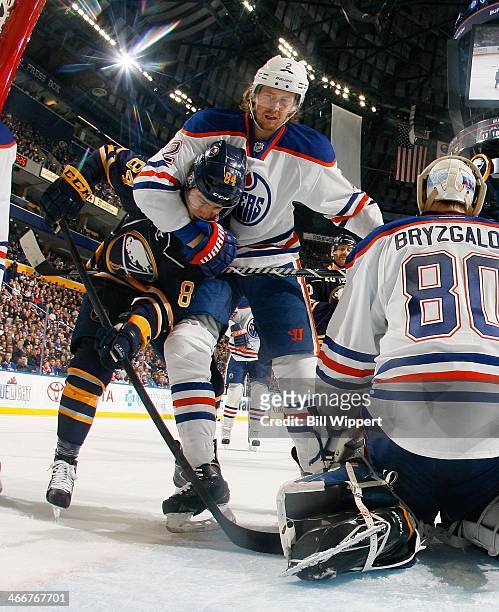Jeff Petry of the Edmonton Oilers grabs hold of Philip Varone of the Buffalo Sabres in front of Oilers goaltender Ilya Bryzgalov on February 3, 2014...