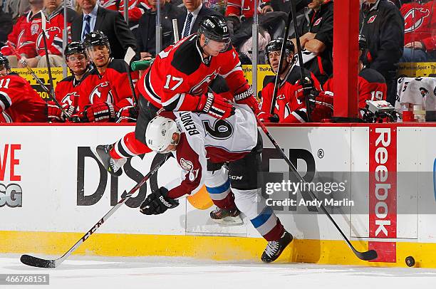 Andre Benoit of the Colorado Avalanche checks Michael Ryder of the New Jersey Devils during the game at the Prudential Center on February 3, 2014 in...