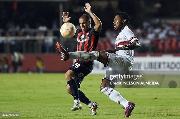 Franco Mussis of Argentina's San Lorenzo, vies for the ball with Michel Bastos of Brazil's Sao Paulo, during their 2015 Copa Libertadores football...