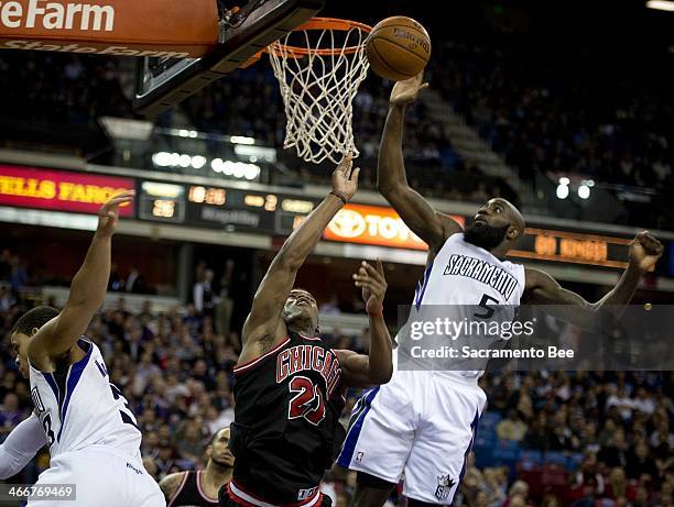 Sacramento Kings small forward Quincy Acy blocks the shot of Chicago Bulls shooting guard Jimmy Butler , who was fouled by Sacramento Kings point...