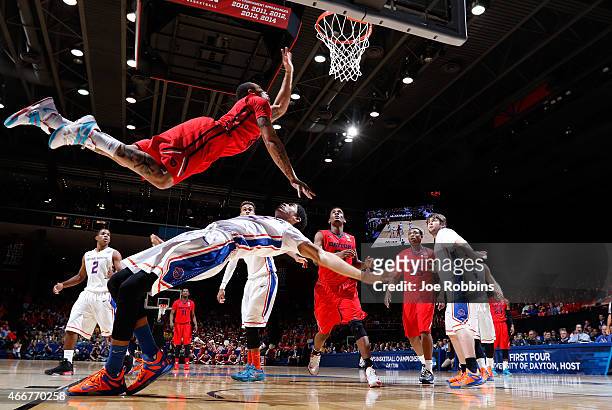 Kyle Davis of the Dayton Flyers goes to the basket against Chandler Hutchison of the Boise State Broncos during the first round of the 2015 NCAA...
