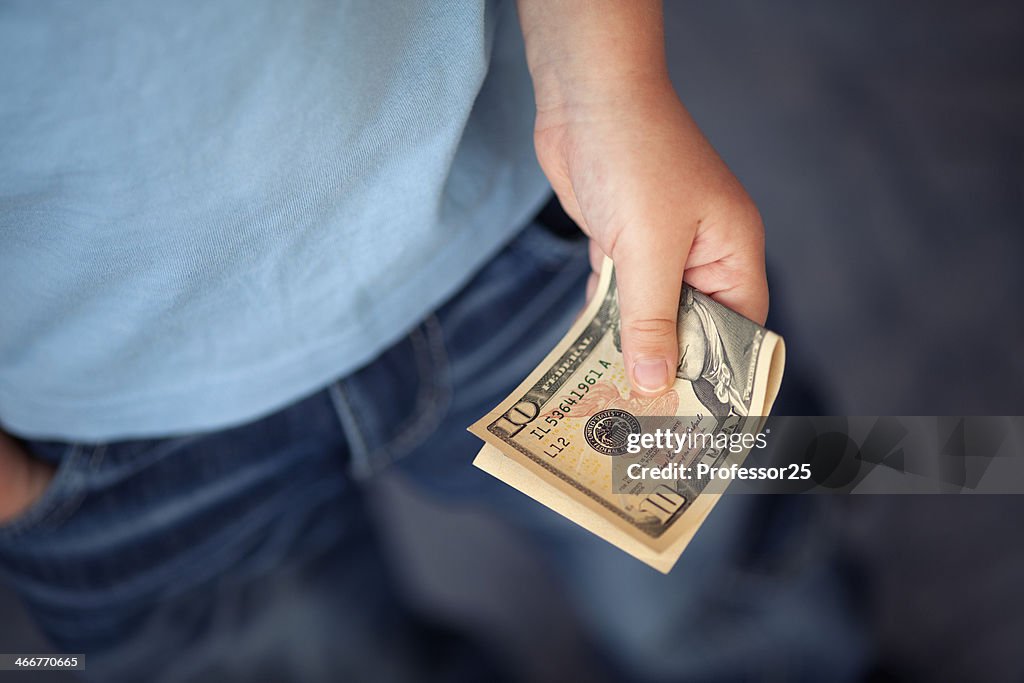 Young boy holds money