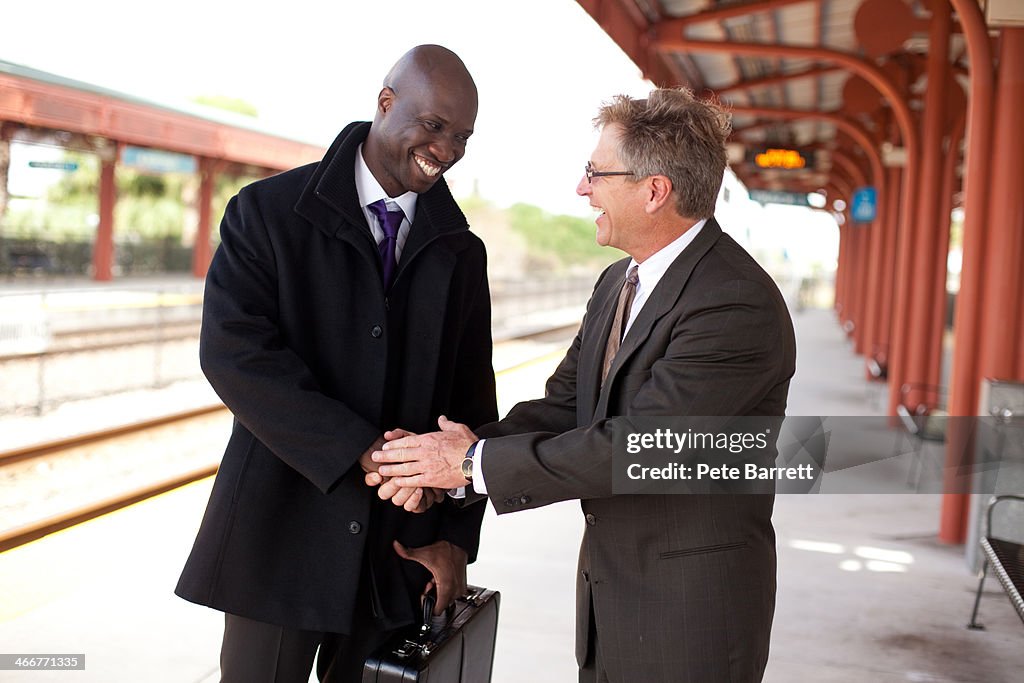 Business men having discussion on train platform