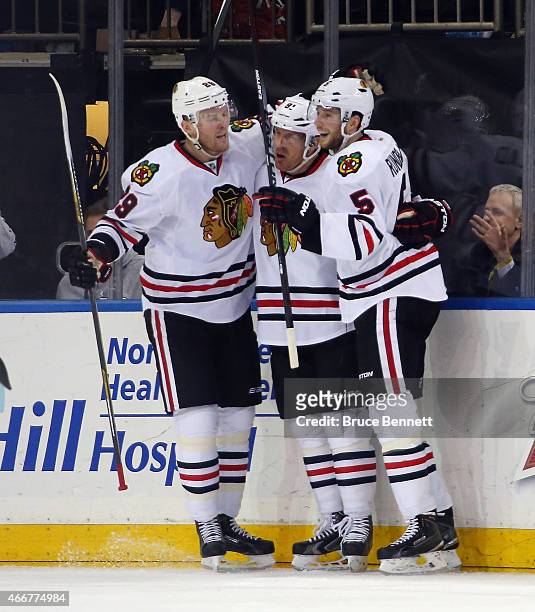 Bryan Bickell, Brad Richards and David Rundblad of the Chicago Blackhawks celebrate Richards game winning goal at 7:19 of the third period against...